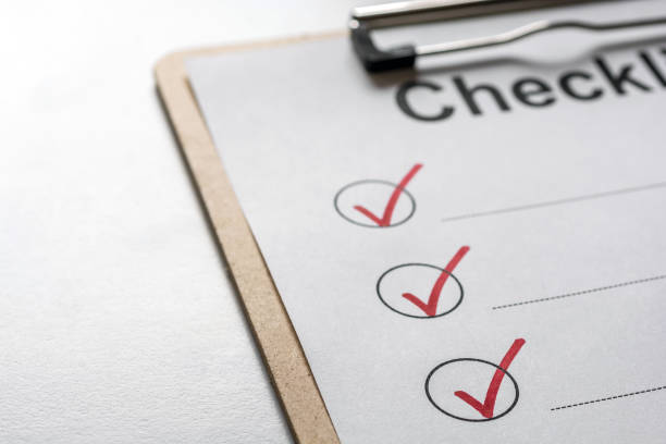 istock Checked checklist on a clipboard is on a bright desk 1170864317