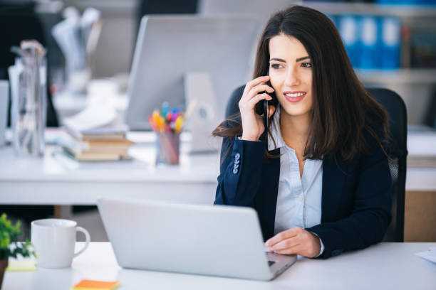 istock Business woman talking on a smart phone in office 1170865530