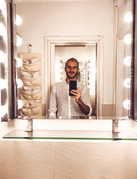 elegance man take a selfie in front of the mirror