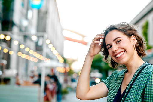 Cropped portrait of an attractive young woman standing alone during a tour of the streets in Portugal