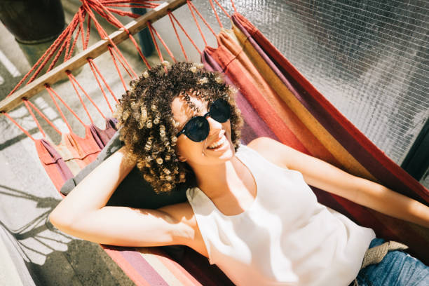 istock Young woman relaxing in hammock 1170867807