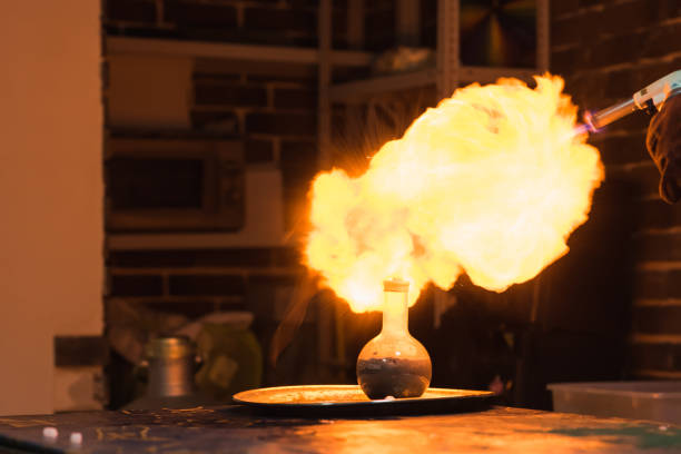 a big explosion of hydrogen in a chemistry room Lab technician setting fire to a ball with hydrogen blowtorch fire inspection stock pictures, royalty-free photos & images