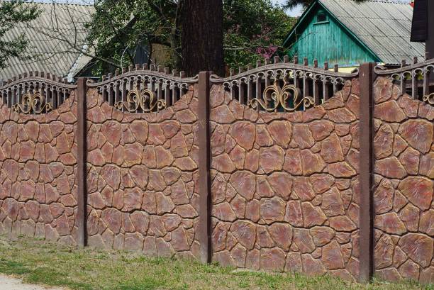 istock brown stone fence outdoors in green grass 1170871601