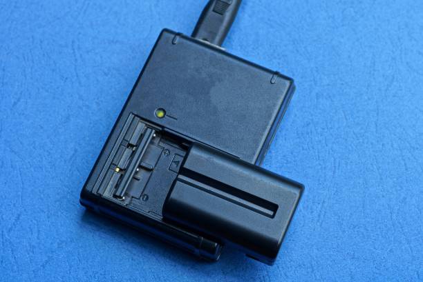 istock one black charger and battery lies on a table 1170871842