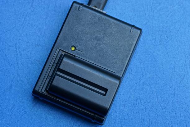 istock charger and battery lies on a blue table 1170871851