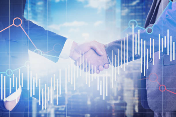 istock Handshake of businessmen in city, graphs 1170872021