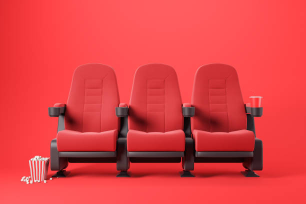 istock Three red cinema chairs on red 1170872388