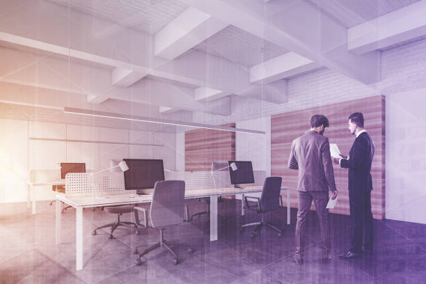 istock Businessmen in white open space office interior 1170872612