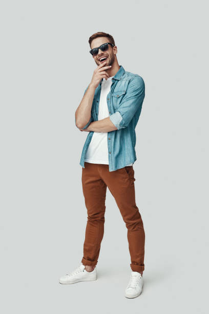 istock Full length of handsome young man looking at camera and smiling while standing against grey background 1170874793