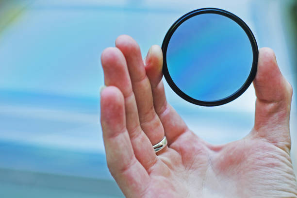istock Polarizing filter in hand. Polarizer for photos against the sky 1170876862