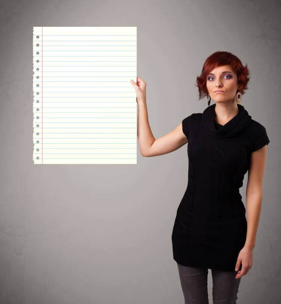 istock Young woman holding white paper copy space with diagonal lines 1170878730