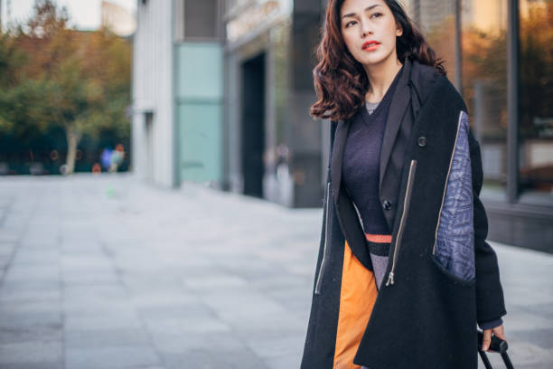 istock Lady with luggage on the street 1170880382