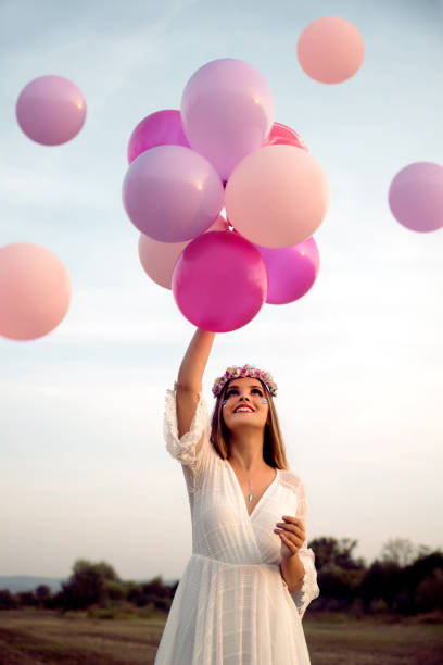 istock Young woman with balloons 1170880527