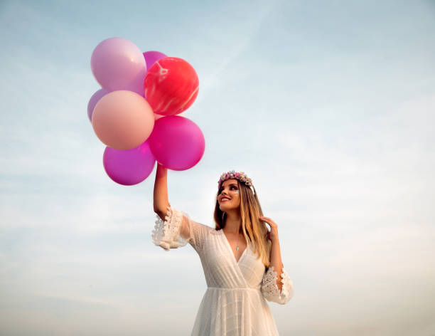 istock Young woman with balloons 1170880534
