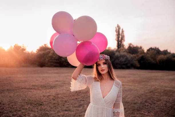 istock Young woman with balloons 1170880552