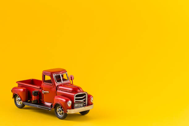 istock Red toy truck on bright yellow background 1170884576