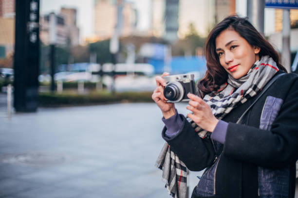 istock Woman photographer downtown 1170888573