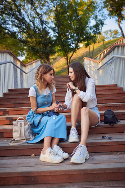istock Two best girlfriends chatting in a summer park. 1170894707