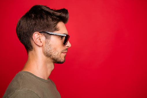Profile photo of amazing, guy looking empty space not smiling wear grey t-shirt isolated on red background