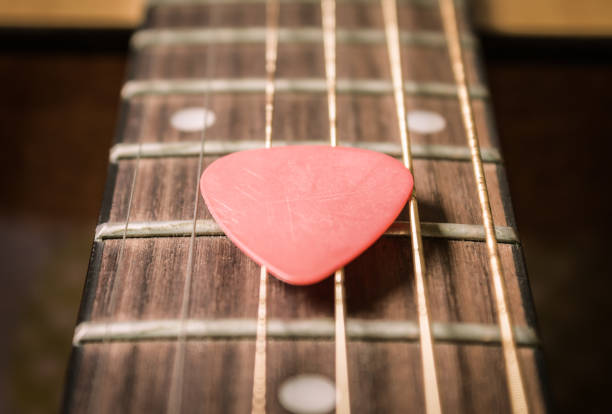 istock Red Pick on Acoustic Guitar String in Vintage Tone 1170896331