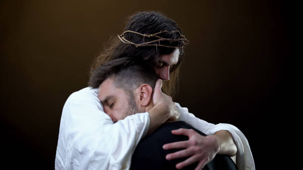 redeemer hugging unhappy man, faith in god, spiritual protection, eternity - christ the redeemer imagens e fotografias de stock