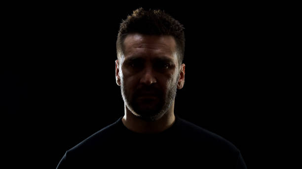 istock Desperate male looking camera on dark background, problem hopelessness, crisis 1170896438