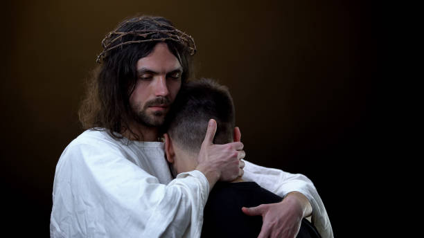 istock Christ hugging depressed parishioner dark background, God kindness, protection 1170896563