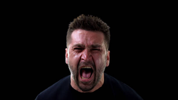 istock Angry man shouting on dark background, emotional breakdown, outburst neurosis 1170896580