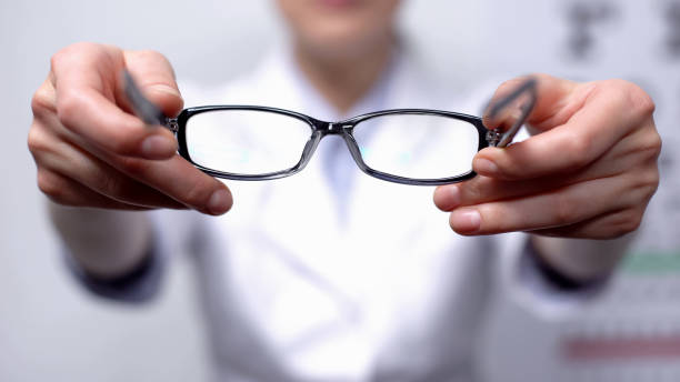 istock Doctor suggesting eyeglasses for person with refocused vision, sight improvement 1170896717