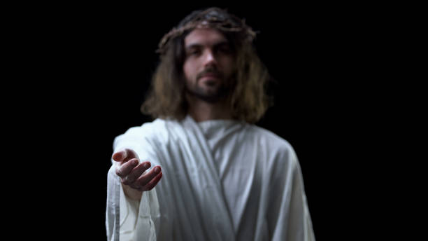 istock Helping hand of savior on dark background, religious help, forgiveness kindness 1170896719