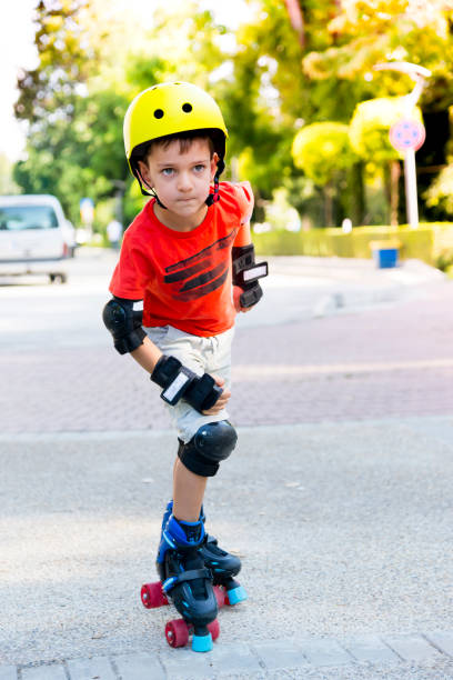 istock Child with roller skates in a sunny summer park. 1170897818