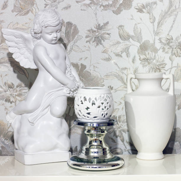 istock Beautiful composition. A figurine is an angel, a jug and a vase 1170898195