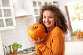 Portrait of beautiful woman holding a  pumpkin
