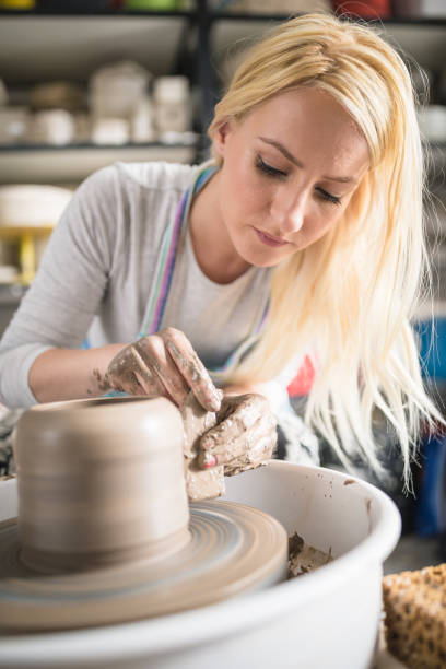 istock Female artist working on potters wheel 1170900547