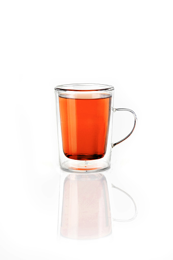 Transparent cup with orange tea
