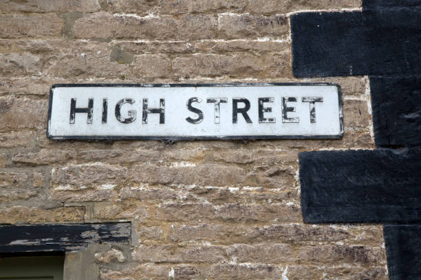 istock High Street Sign on Stone Wall 1170901282