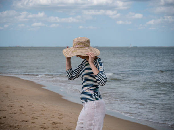 istock Mature woman with beach hat 1170901966