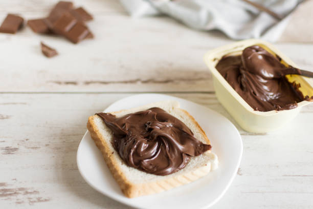 istock Delicious toast bread with chocolate paste on plate closeup. 1170902593