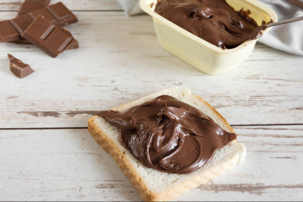 istock Delicious toast bread with chocolate paste on plate closeup. 1170902629