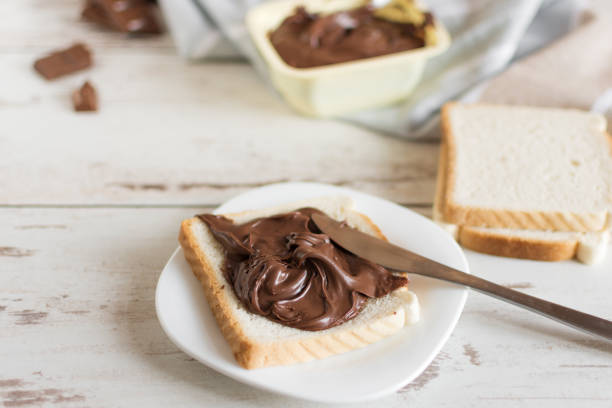 istock Delicious toast bread with chocolate paste on plate closeup. 1170902659
