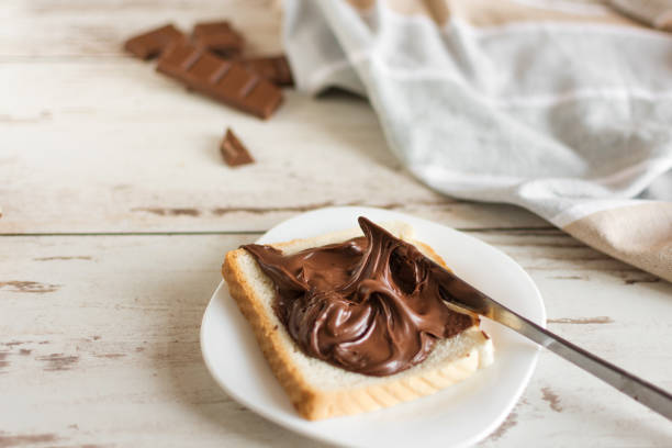 istock Delicious toast bread with chocolate paste on plate closeup. 1170902666