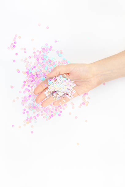 istock Pearl pastel confetti sparkles with woman hand 1170909094