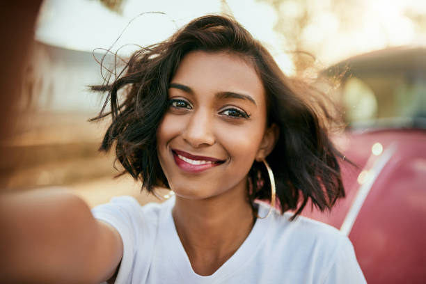 Selfie time Cropped portrait of an attractive young woman standing against her car and taking a selfie alone during a day out selfie photos stock pictures, royalty-free photos & images
