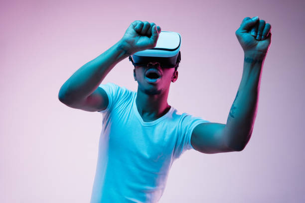 istock Young african-american man's using VR-glasses in neon light 1170912070