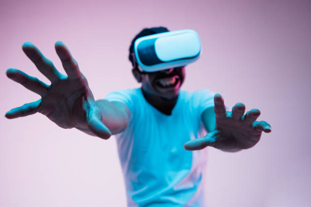 istock Young african-american man's using VR-glasses in neon light 1170912109