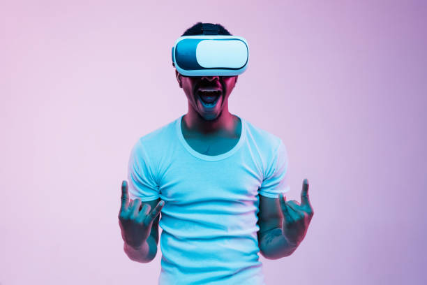 istock Young african-american man's using VR-glasses in neon light 1170912173