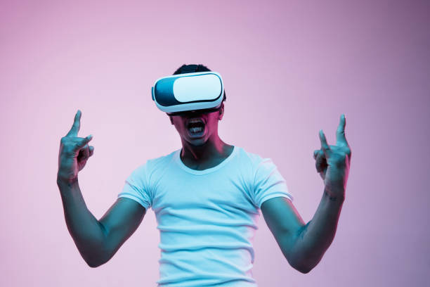 istock Young african-american man's using VR-glasses in neon light 1170912181
