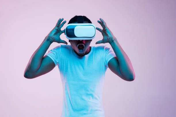 istock Young african-american man's using VR-glasses in neon light 1170912222