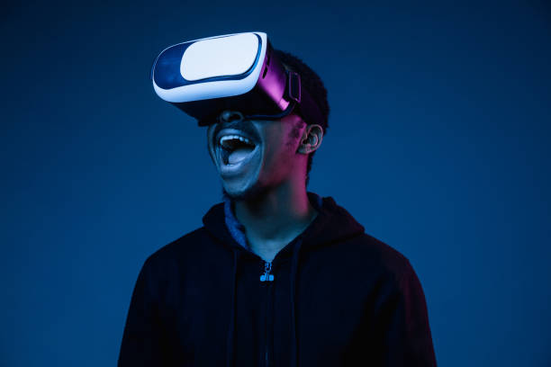 istock Young african-american man's using VR-glasses in neon light 1170912291