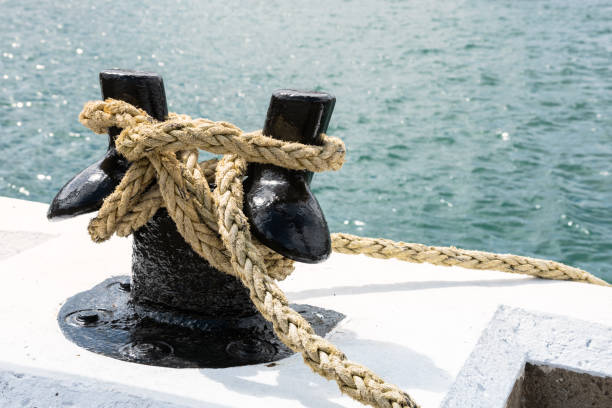 istock Black Mooring bollard wiht a knotted rope 1170914087